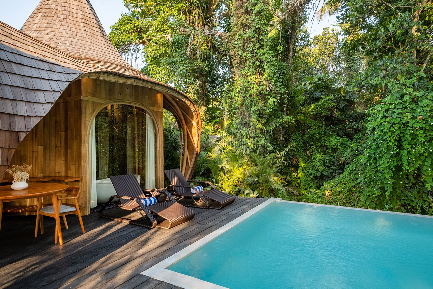Jungleight Bali bamboo terrace with woven loungers overlooking the jungle